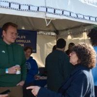 Suzanne Zack talking to people at the Film/Video Alumni Affinity Network tent